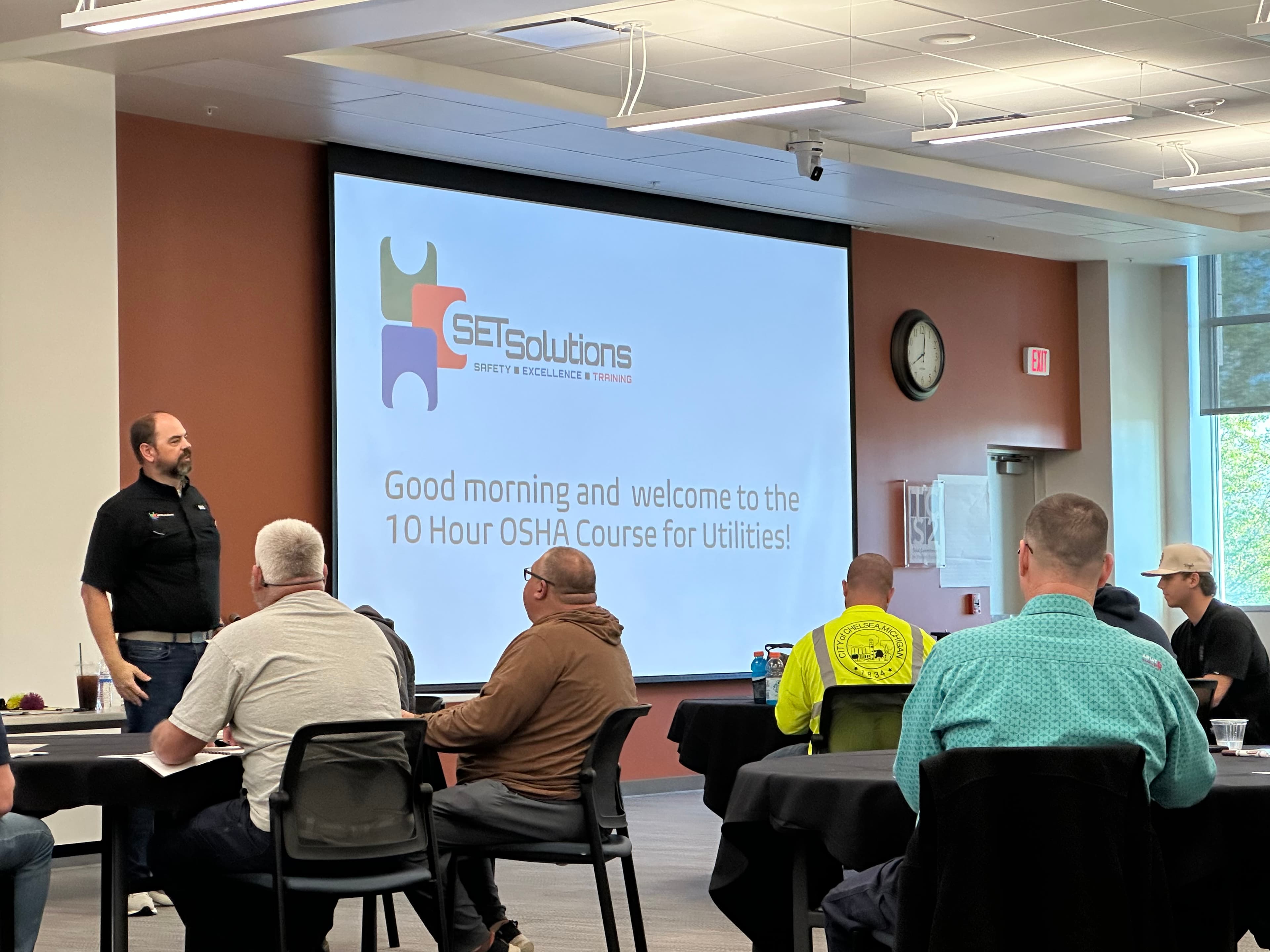 Instructor leading an OSHA classroom session for utility workers